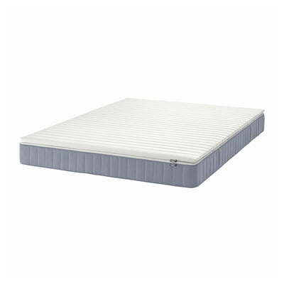 A VESTERÖY pocket spring mattress in white and grey, rectangular, with a padded surface and raised edges.
