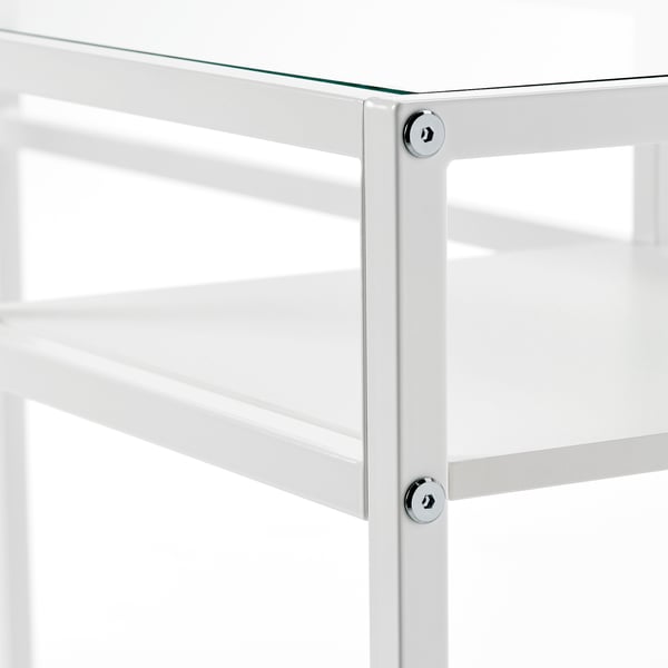 Modern glass and metal shelf unit with adjustable and fixed shelves, demonstrating sturdy construction and sleek design.