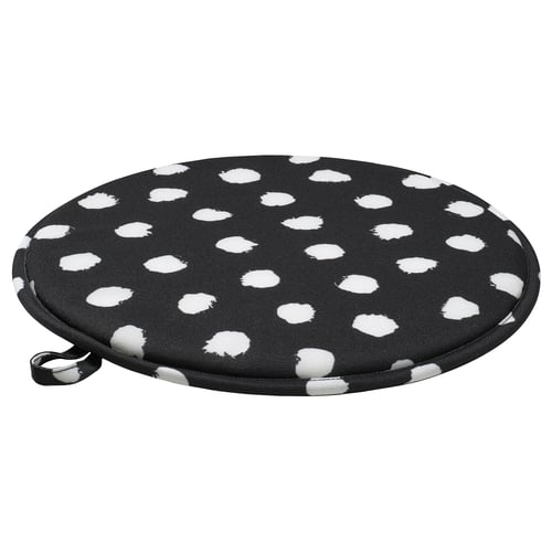 Round black chair pad with white dots, recycled polyester, non-slip base.