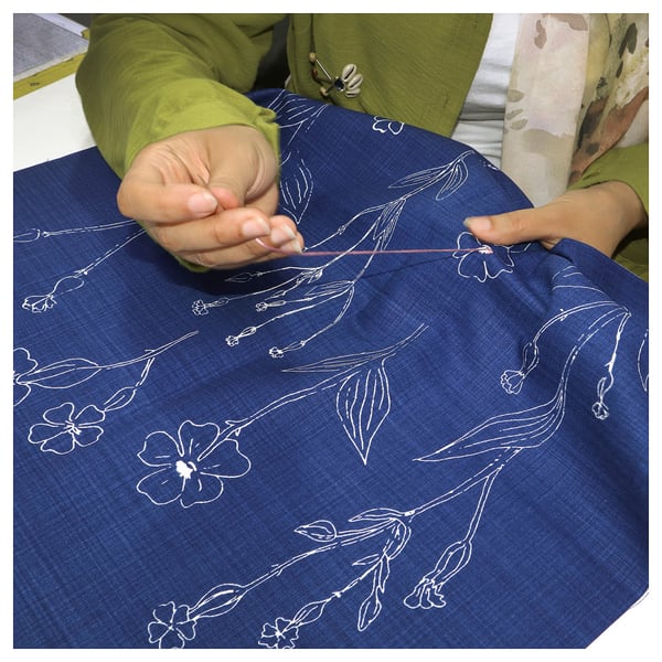 ÅKERNEJLIKA blue floral cushion. Hand-embroidered cotton, rectangular.