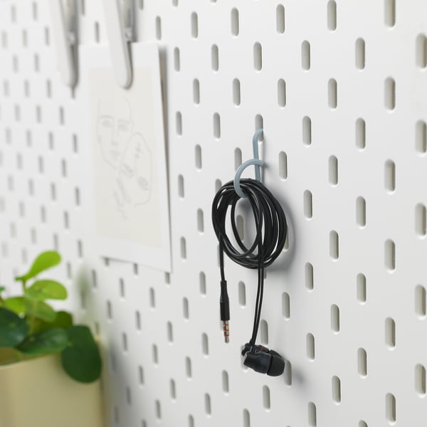 A pegboard mounts earphones with ALFORSIT cable ties, utilising hooks for organised storage.