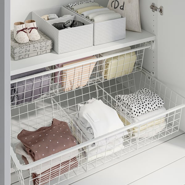 White wire closet organisers hold folded clothes neatly. Baskets roll smoothly, enhancing accessibility.