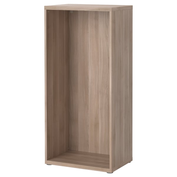 An IKEA BESTÅ storage unit in light brown, made of particleboard and fibreboard. Its rectangular with four adjustable feet and no shelves or doors.