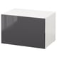 An IKEA BESTÅ storage unit in white and dark grey. Its rectangular, modern, and minimalistic.