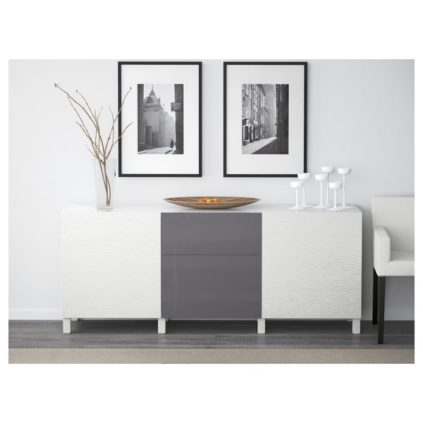 Modern sideboard with hidden drawers, wine glasses, and framed photos.