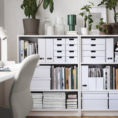 White BILLY bookcase with books, plants, and vases in home office.