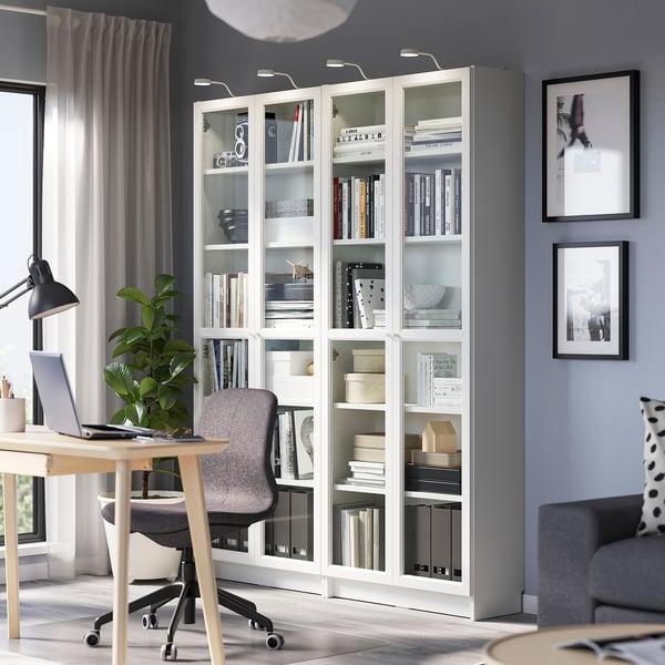 Home office with BILLY bookcase, desk, and couch.