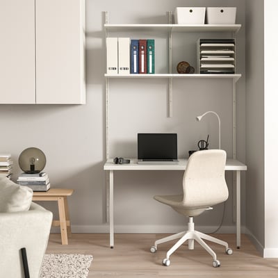 A modern home office with BOAXEL desk, chair, laptop, and lamp.