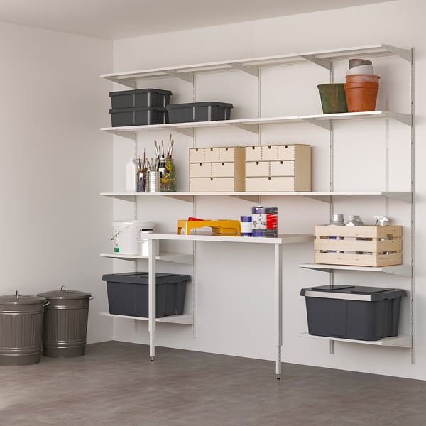 White wall storage with shelves & bins, tidy tools.