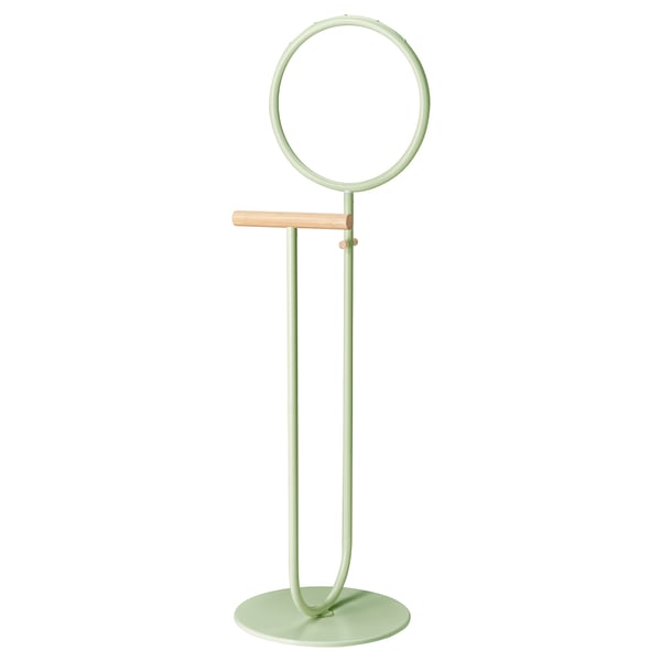 A green metal and bamboo valet stand. It has a circular top and a wooden bar for hanging clothes. The base is flat and round.