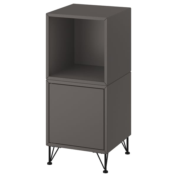 An EKET storage unit in black. It has a modern design with both open and closed compartments, supported by metal legs.