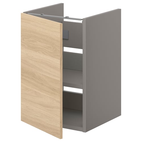 An ENHET bathroom cabinet in oak with a grey interior and one shelf.