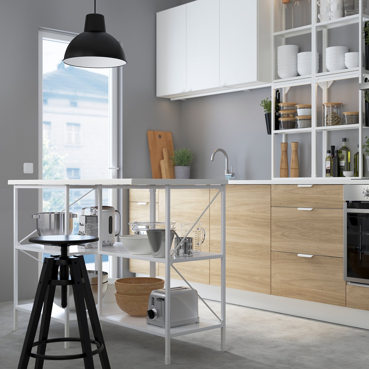 Modern kitchen with ENHET island, open shelves, bowl, stool, dishes, cutting board, plant, and large window.