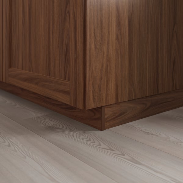 Wooden kitchen plinth in dark brown, covering floor gap, adding a classic touch.