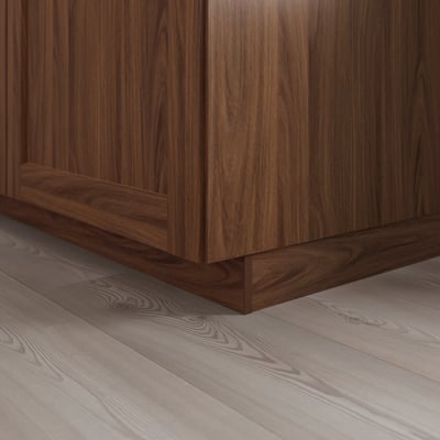 Wooden kitchen plinth in dark brown, covering floor gap, adding a classic touch.