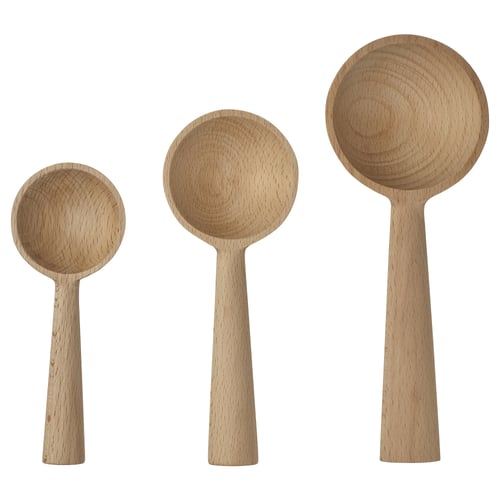 Three wooden spoons, light brown colour, varying in size, placed side by side, displaying smooth and curved designs.