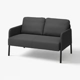 Dark grey, compact GLOSTAD sofa with sleek design and metal legs.