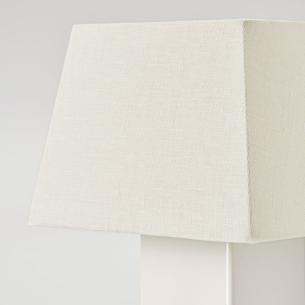 Close-up of elegant lamp shade. Soft, textured linen in warm white, reflecting quality craftsmanship.