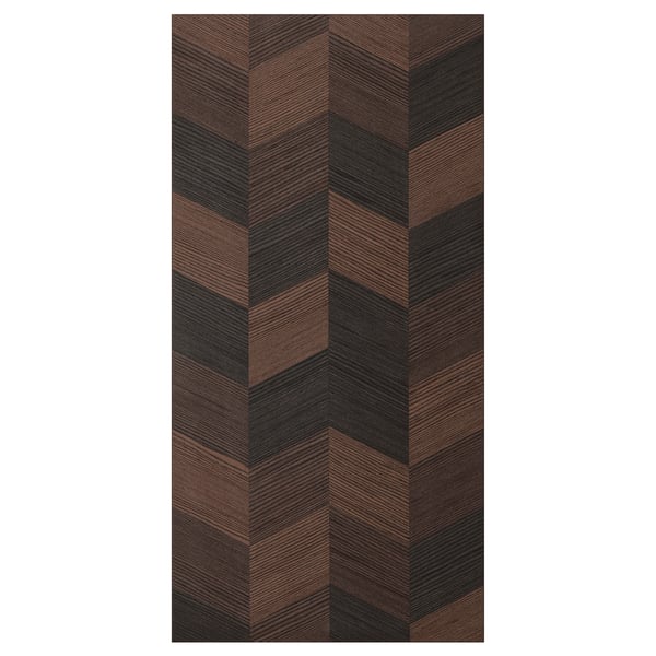 A rectangular HASSLARP door with a brown, black, & light wood herringbone pattern. Its sleek & modern, crafted from wood veneer.