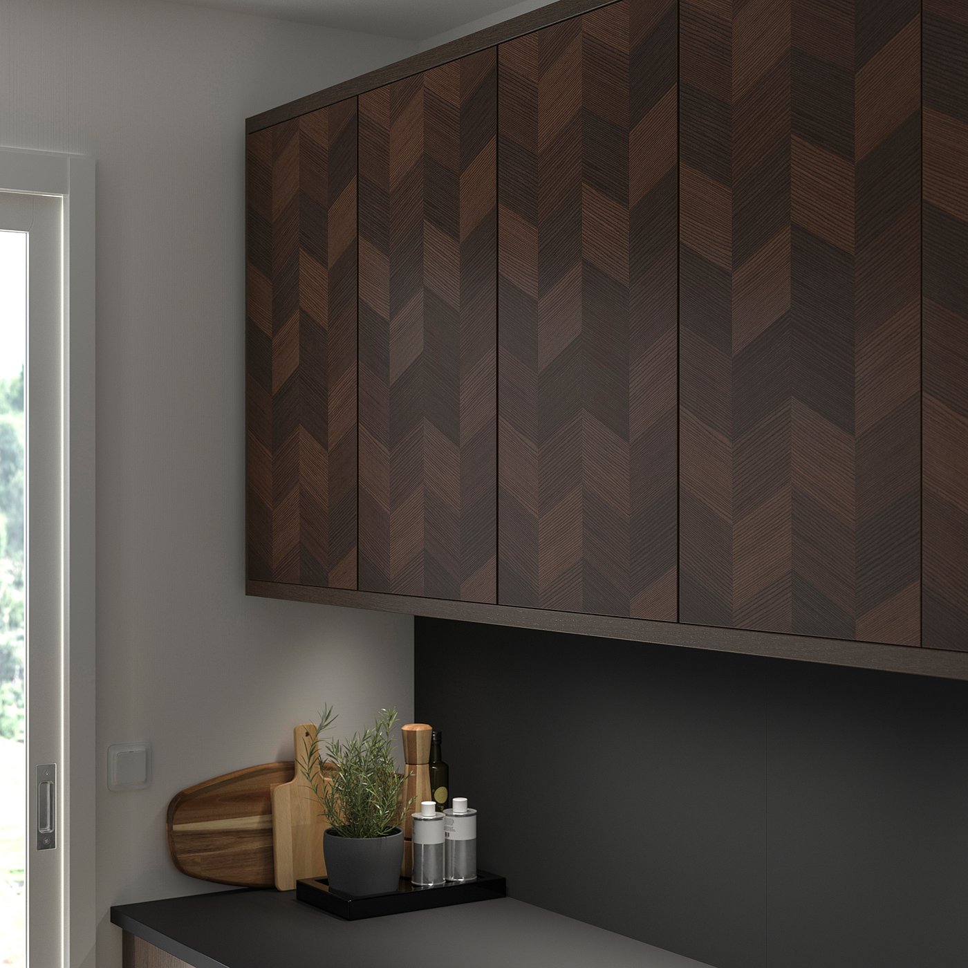 Brown herringbone wooden cabinets with cutting board, plant, and items on countertop.