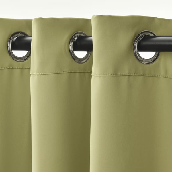 Olive green curtains with silver grommets for light blocking and privacy.