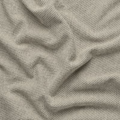 Close-up of a soft, textured fabric with subtle patterns, likely a sofa or curtain material, showcasing its fine texture and quality weave.