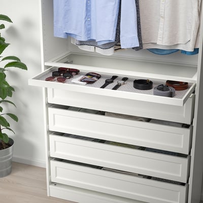 White drawer organiser with felt mat for accessories.
