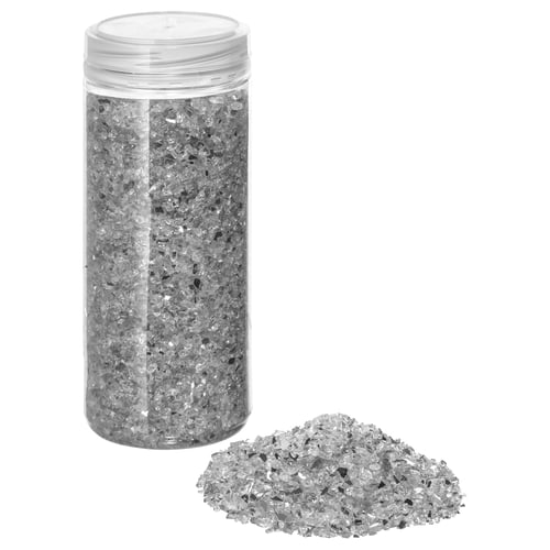 Silver jar with glass shards.