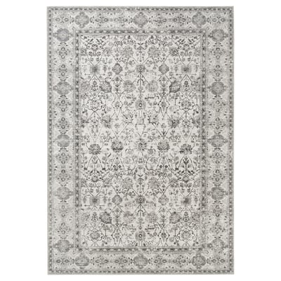 A large, rectangular LOKALTÅG area rug in a neutral grey with intricate floral patterns.