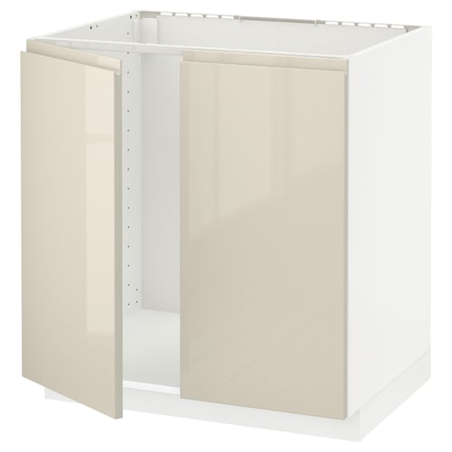 A METOD kitchen cabinet in high gloss beige with integrated handles. It’s a modern, white and beige unit with smooth surfaces and a sturdy frame.