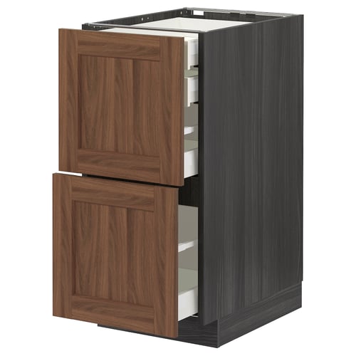 METOD kitchen cabinet with walnut drawers and black sides.