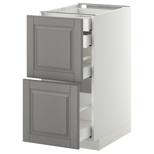 A grey METOD kitchen cabinet with multiple drawers, featuring a traditional design with bevelled edges and a warm appearance.