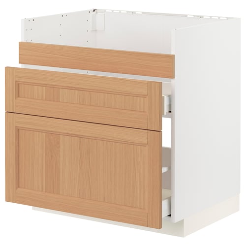 An ikea METOD kitchen unit in white with oak drawer fronts. It has three drawers, each with a wooden panel design.