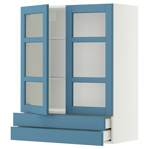 Displays a blue and white METOD storage cabinet. It glass doors, adjustable shelves, and a drawer.