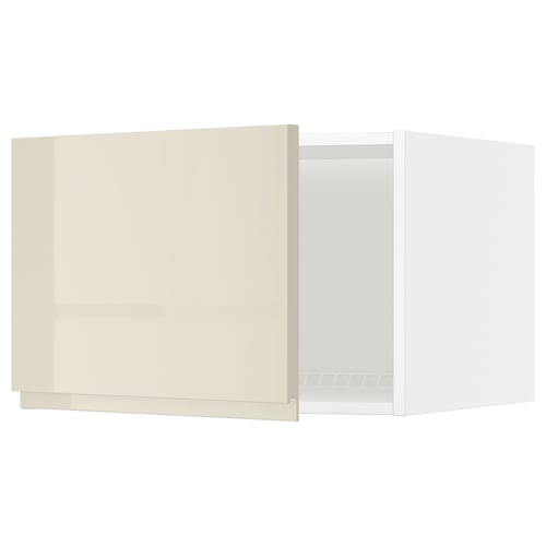 A beige IKEA METOD kitchen cabinet with a high gloss finish and a handle-less design.
