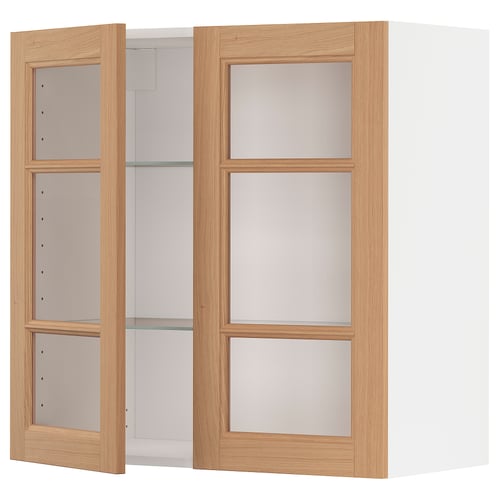 A wooden METOD wall cabinet with glass doors in natural oak. It has three shelves and a sleek, modern design.