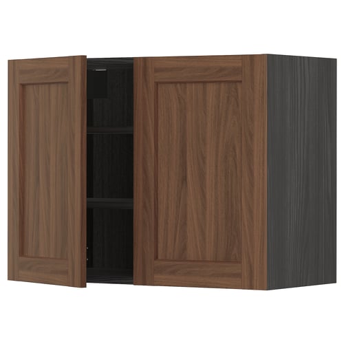 A brown METOD kitchen wall cabinet with one door open, revealing shelves inside.