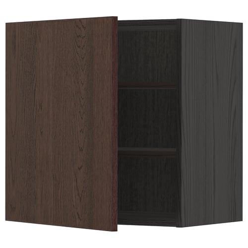 A METOD dark brown kitchen cabinet with a wooden door partially open, revealing two shelves inside.
