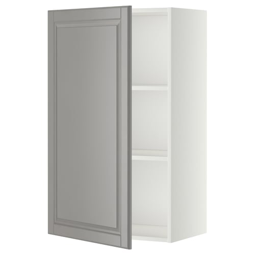 A white METOD kitchen cabinet with a grey door featuring bevelled edges. The design is traditional, with a wooden frame and adjustable shelves.