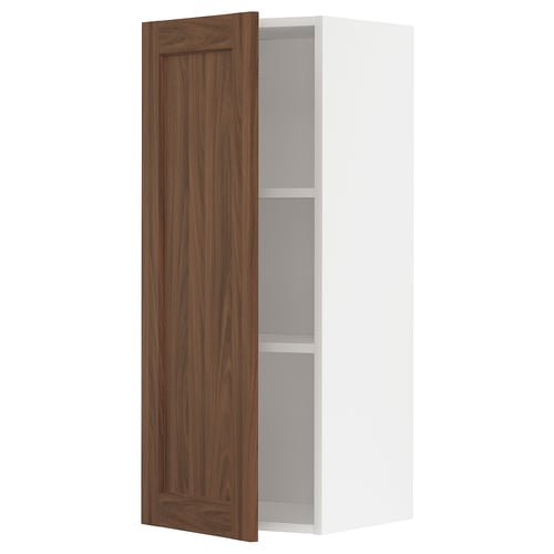 An open METOD kitchen cabinet with a single adjustable shelf and a walnut-colored door.