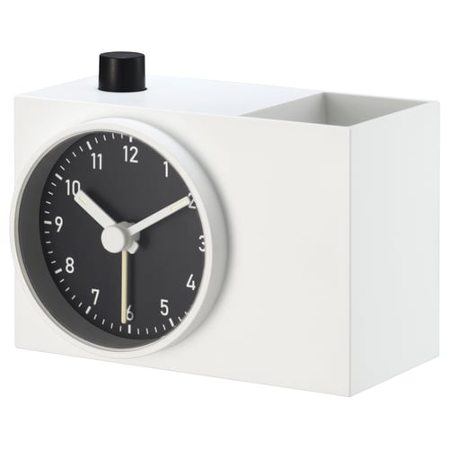 A modern white clock named ÖKENMARSVIN made from recycled abs plastic with a black circular face and white hands.