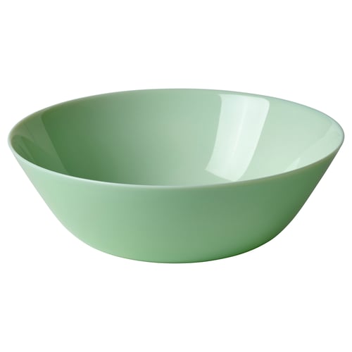 A green glass bowl, named OFTAST, with a smooth, simple design. Its suitable for various uses and dishwasher-safe.