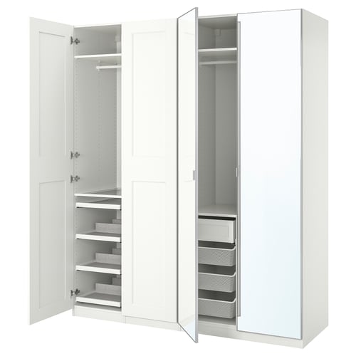 A white IKEA PAX wardrobe with open sections revealing shelves, drawers, and hanging space.