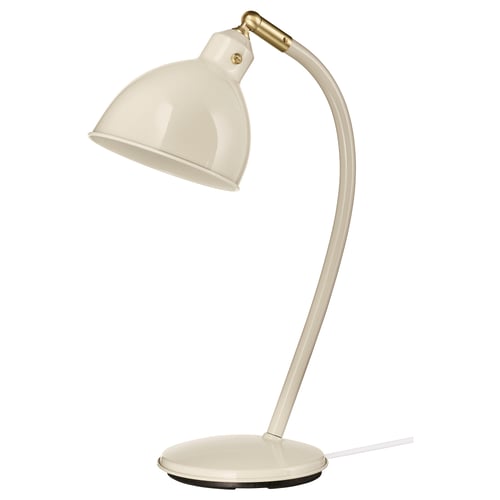 The RÖDFLIK lamp is a sleek white desk lamp with a curved neck, adjustable shade, and brass accents.