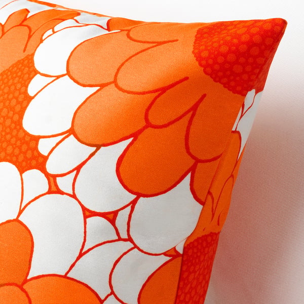 Vibrant, textured pillow with large orange flowers on a white background, showcasing high-quality, colourful design.