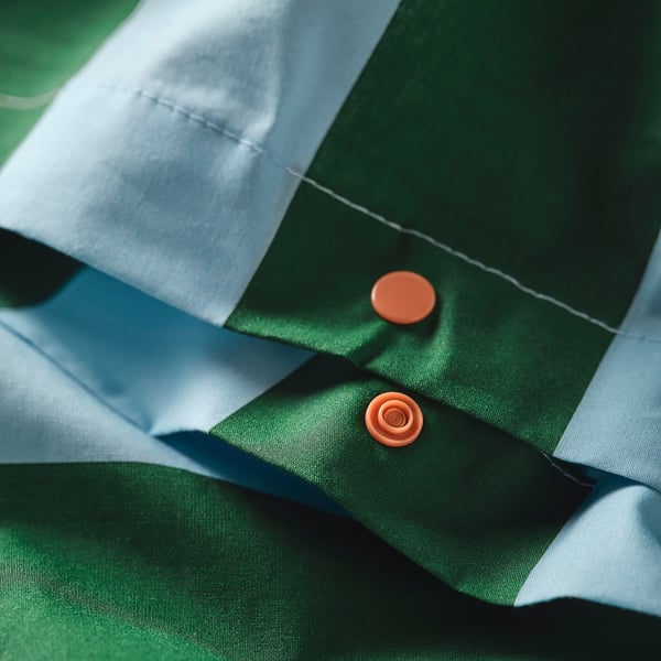 Green and white striped duvet cover with orange buttons, part of SLÅNHÖSTMAL set.