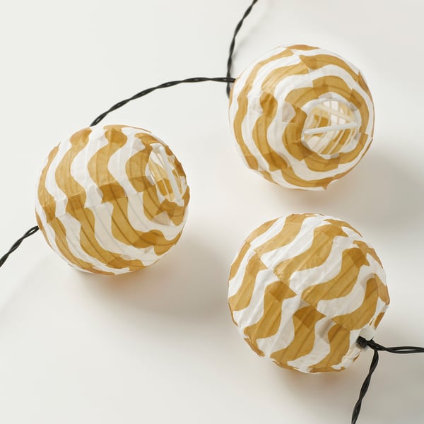 Spherical lanterns with gold, white patterns, softly glowing, indoor/outdoor.