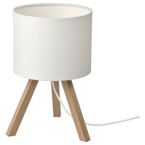 A STORSEGEL lamp with a white shade and wooden tripod legs. The design is modern and minimalist.
