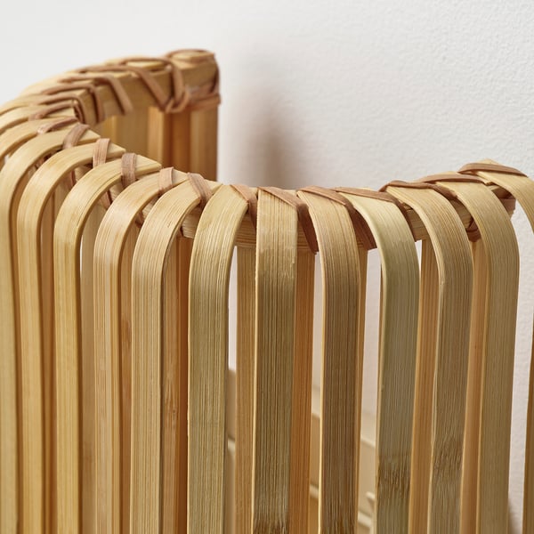 Close-up of intricately woven bamboo lamp shade, showcasing natural texture and craftsmanship.