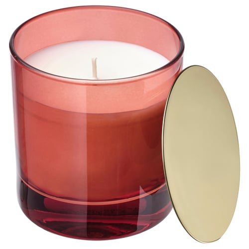 VINTERFINT candle: red glass, gold lid, rounded shape. Emits orange and cloves scent.